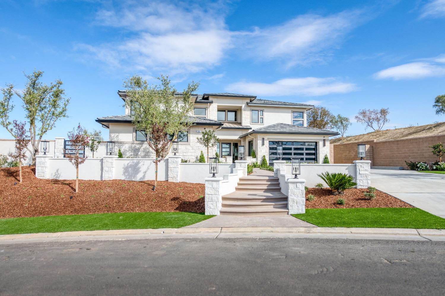 881 Terrace Place Madera, CA 93636 - Photo 7 of 85 a front view of a house with a garden and pathway