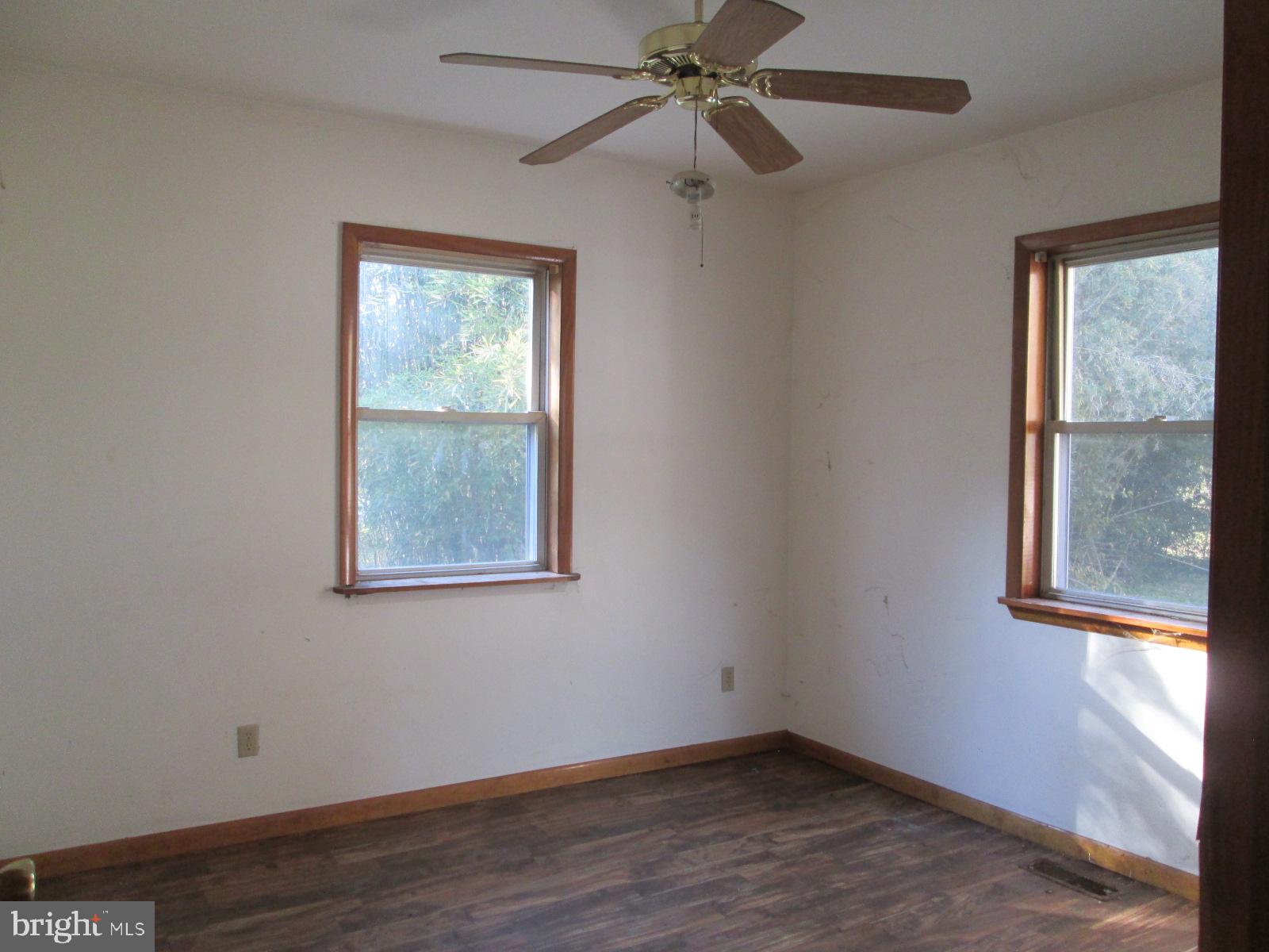 1600 Philadelphia Road Joppa, MD 21085 - Photo 16 of 20 an empty room with wooden floor fan and windows