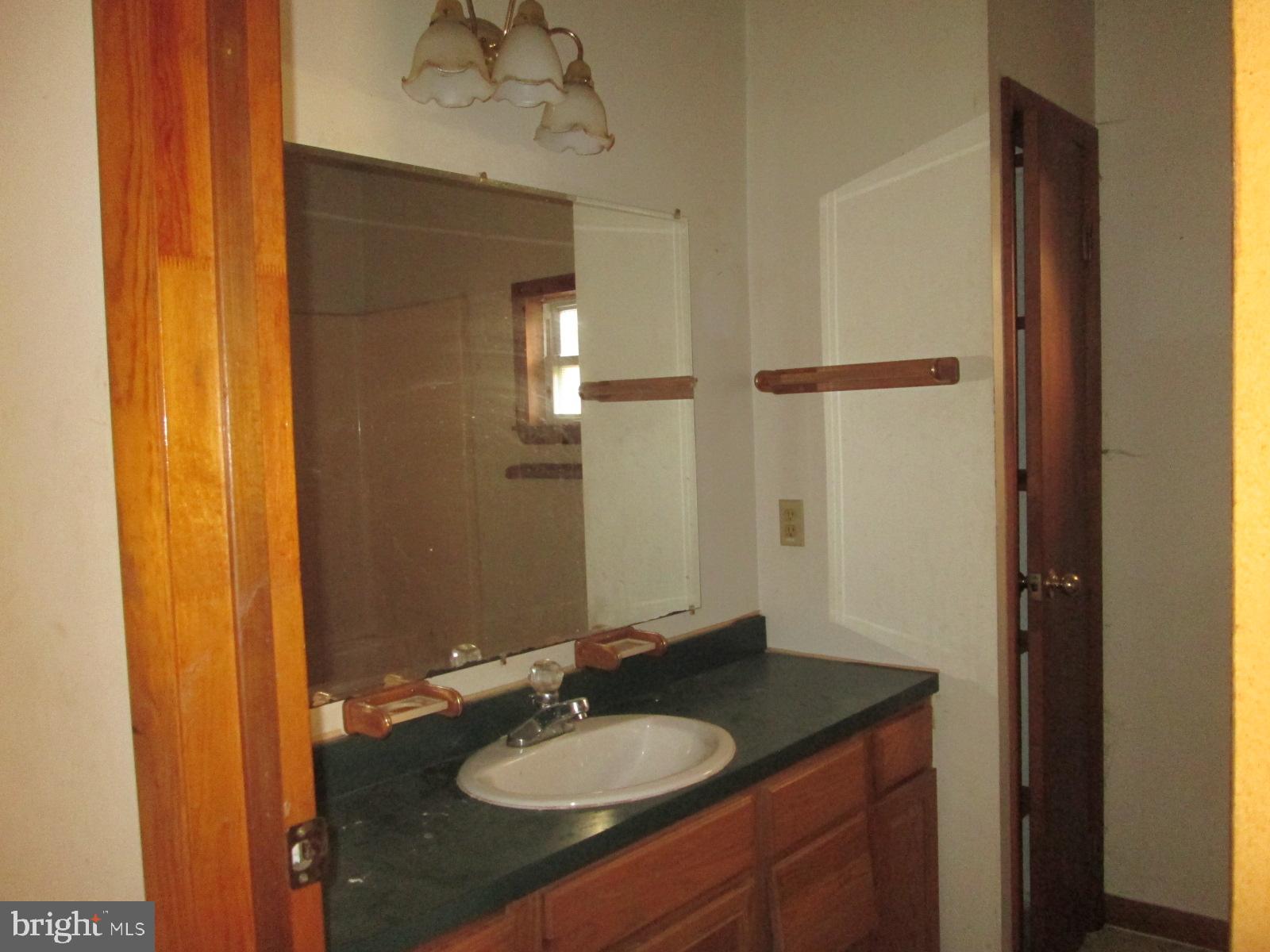1600 Philadelphia Road Joppa, MD 21085 - Photo 19 of 20 a bathroom with a granite countertop sink and a mirror