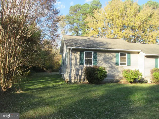 a view of a backyard with table and chairs and potted plants