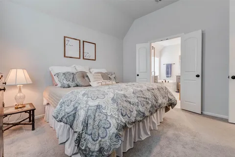 a bedroom with a bed and a lamp