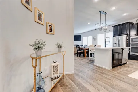 a view of a kitchen with furniture and wooden floor