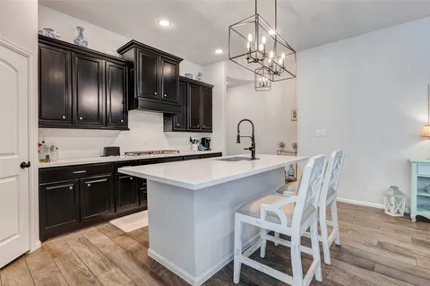 a kitchen with stainless steel appliances a sink stove and refrigerator