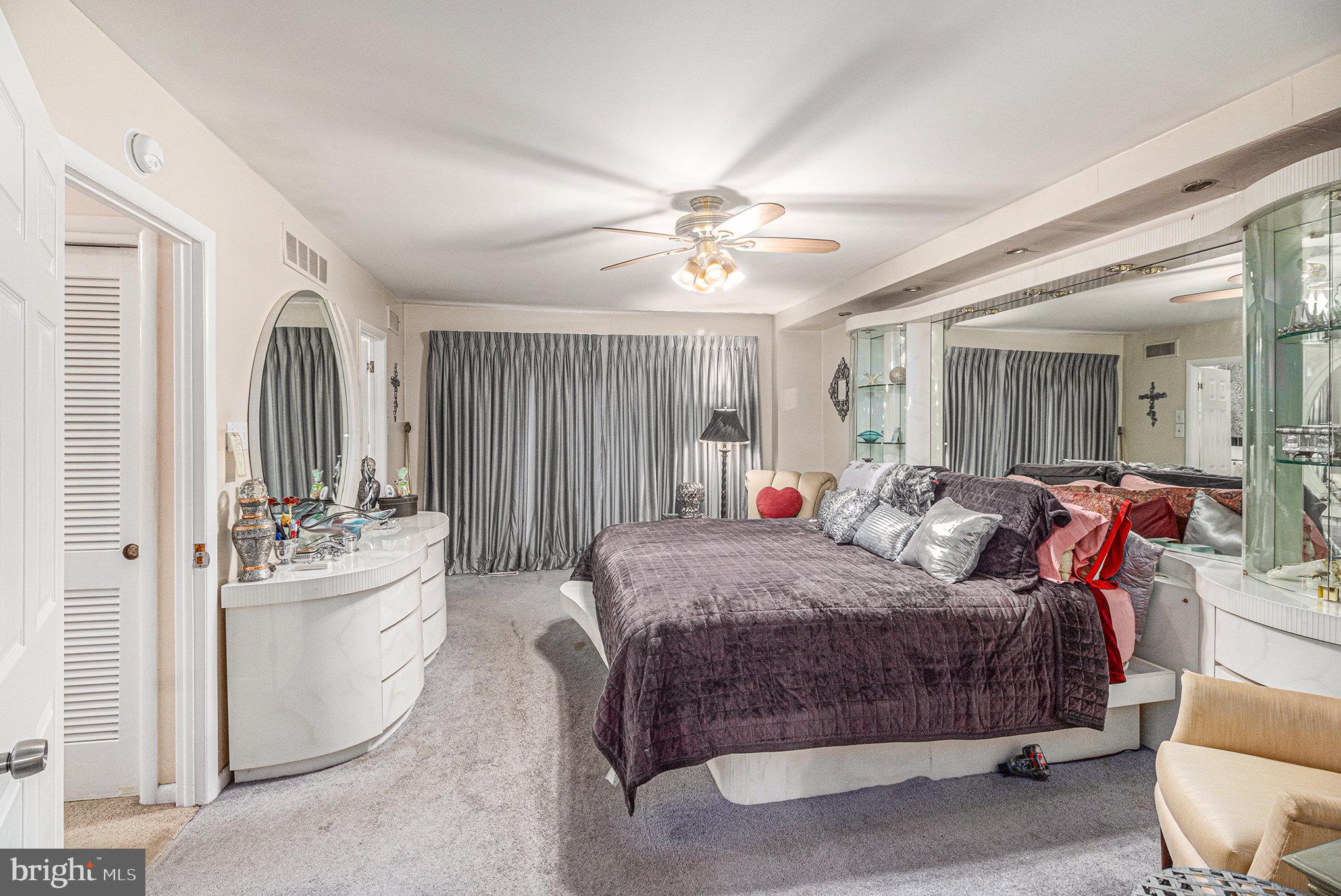 407 Rices Mill Road Wyncote, PA 19095 - Photo 11 of 29 a spacious bedroom with a bed and a chandelier