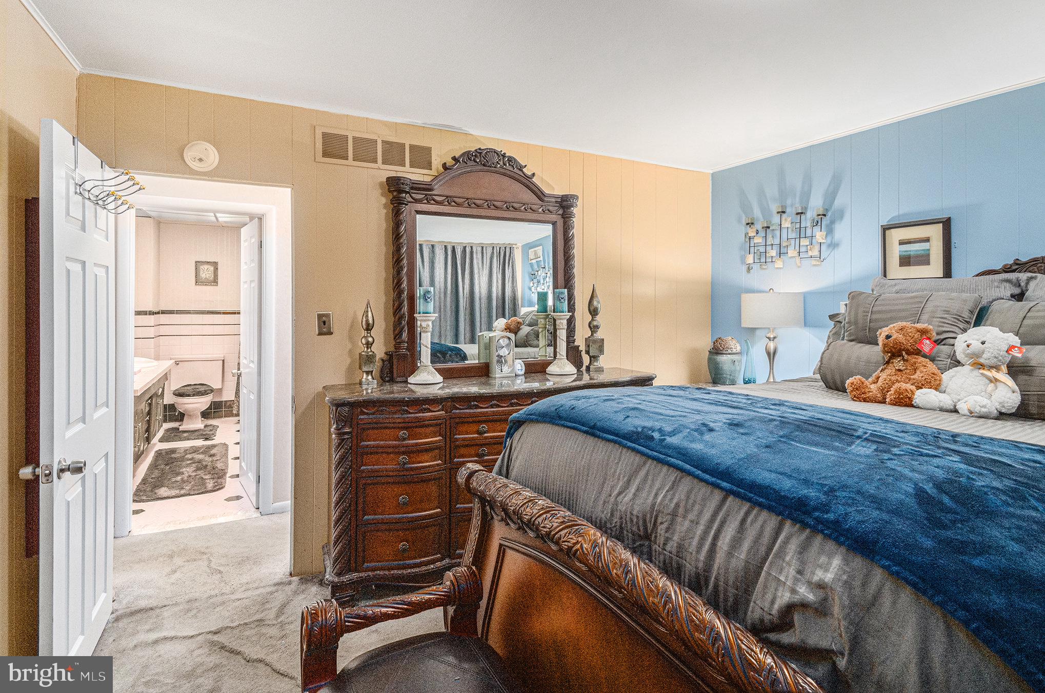 407 Rices Mill Road Wyncote, PA 19095 - Photo 17 of 29 a bedroom with a bed and large mirror on the dresser