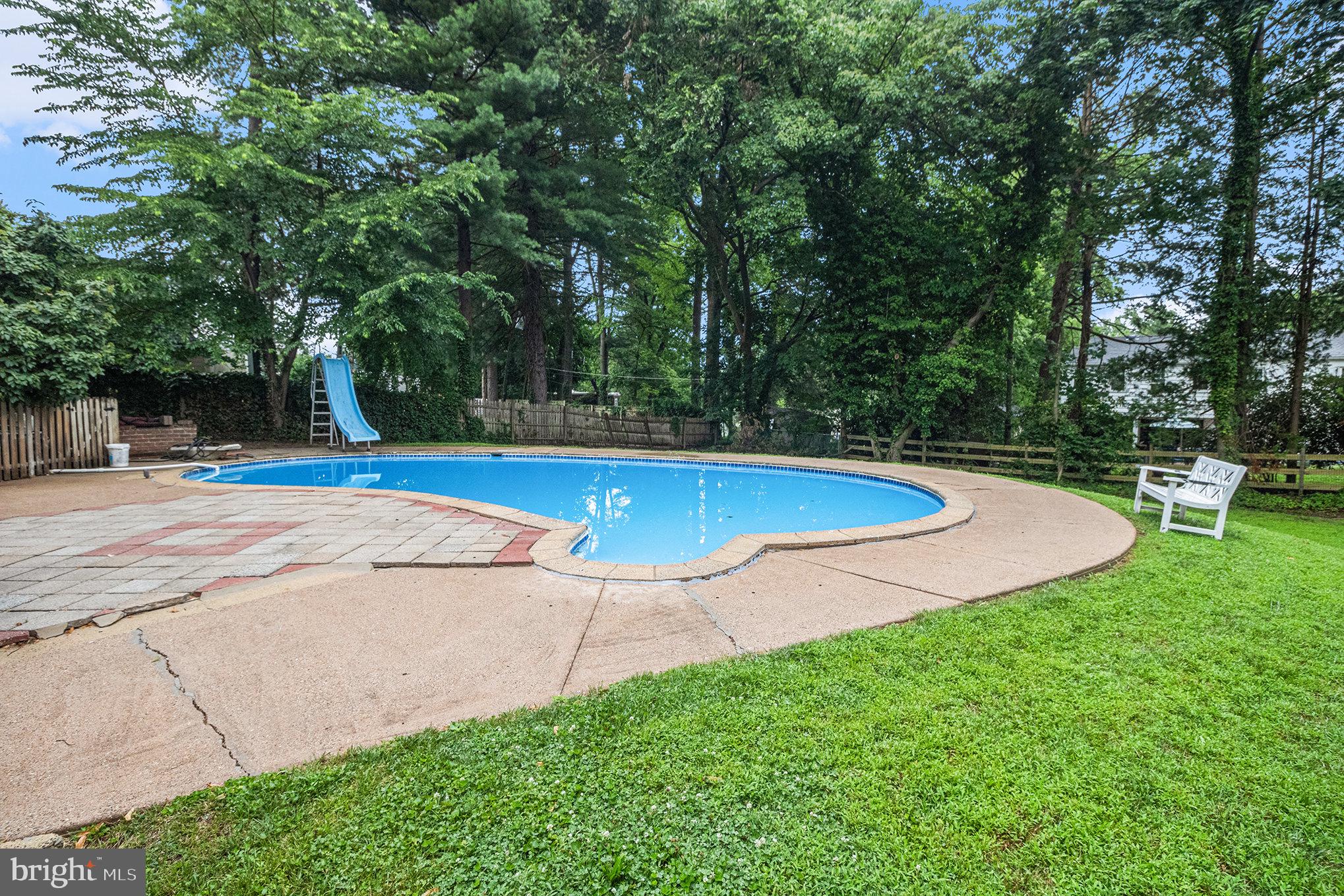407 Rices Mill Road Wyncote, PA 19095 - Photo 26 of 29 a view of a swimming pool with a bench and trees around