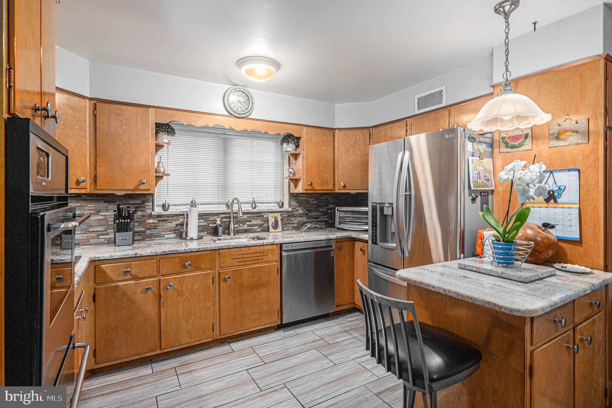 407 Rices Mill Road Wyncote, PA 19095 - Photo 8 of 29 a kitchen with a stove a sink and a refrigerator