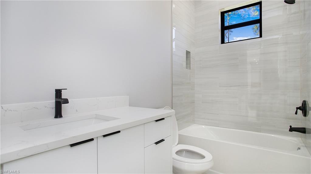 3518 2nd Avenue Southeast Naples, FL 34117 - Photo 19 of 41 a bathroom with a sink a toilet and a bathtub