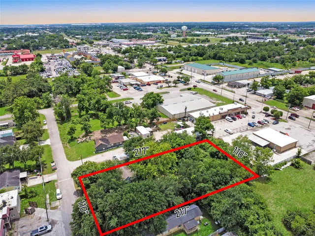 an aerial view of residential house with outdoor space and trees