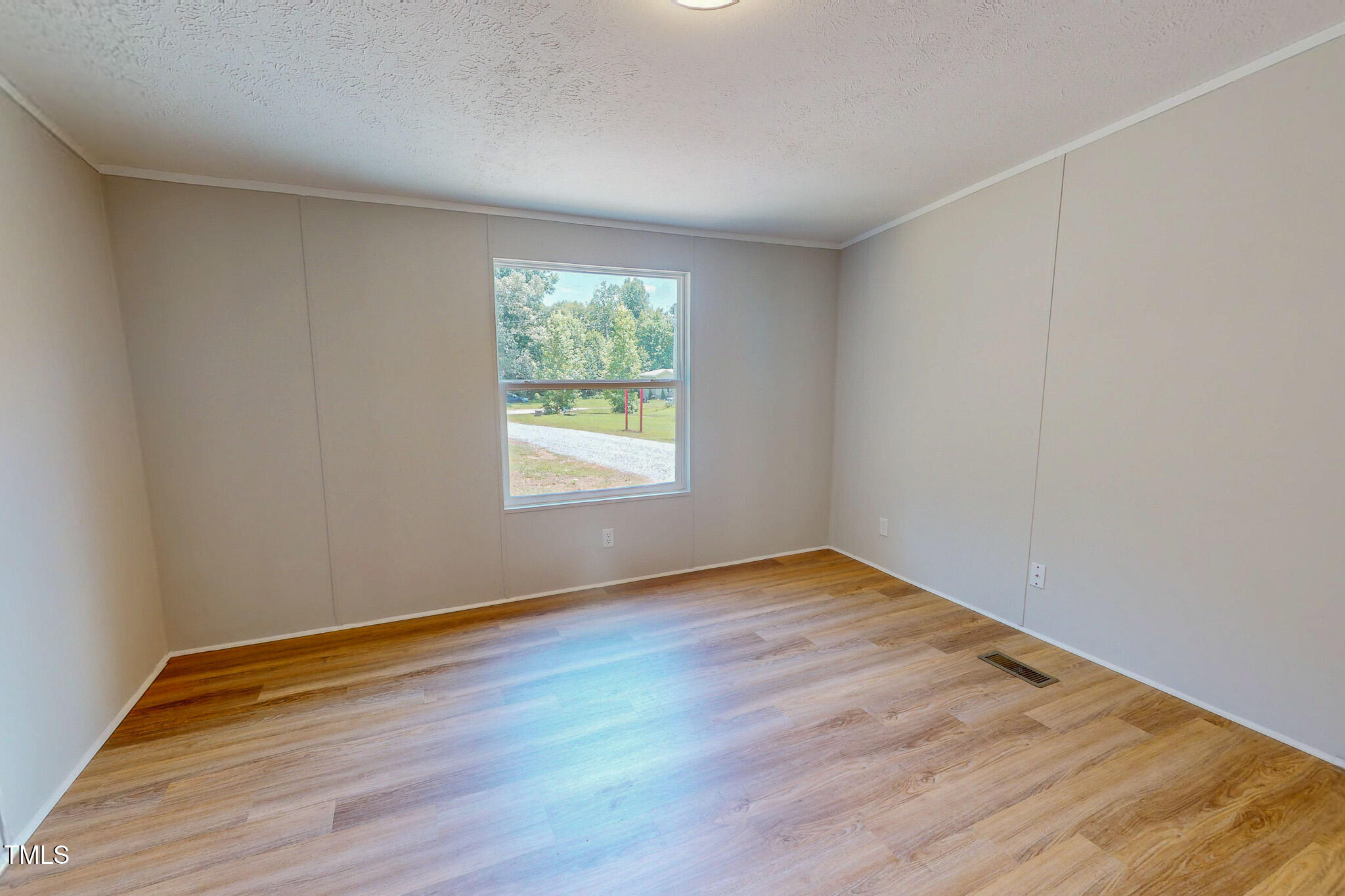 72 Red Field Lane Timberlake, NC 27583 - Photo 11 of 36 an empty room with wooden floor and windows
