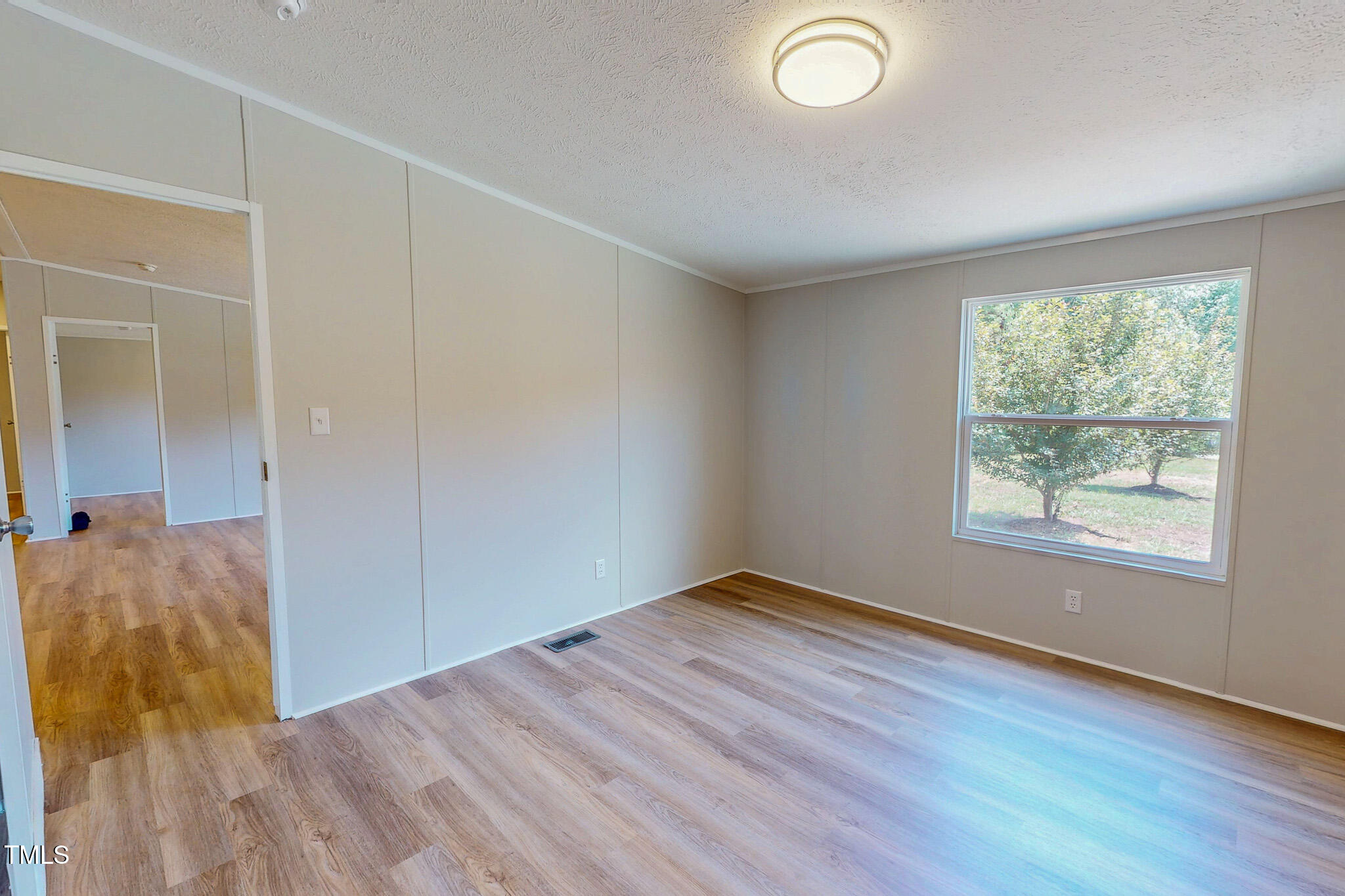 72 Red Field Lane Timberlake, NC 27583 - Photo 18 of 36 an empty room with wooden floor and windows