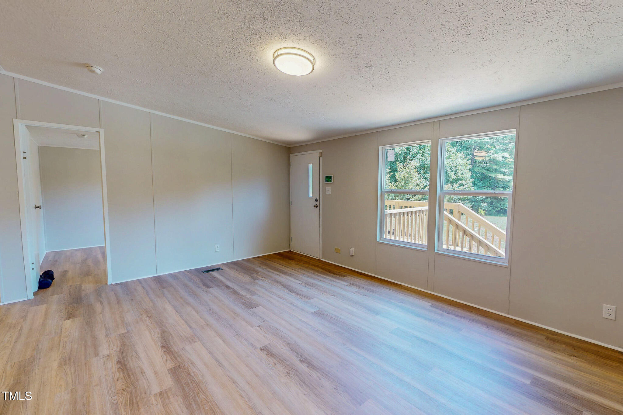 72 Red Field Lane Timberlake, NC 27583 - Photo 19 of 36 a view of an empty room with wooden floor and a window