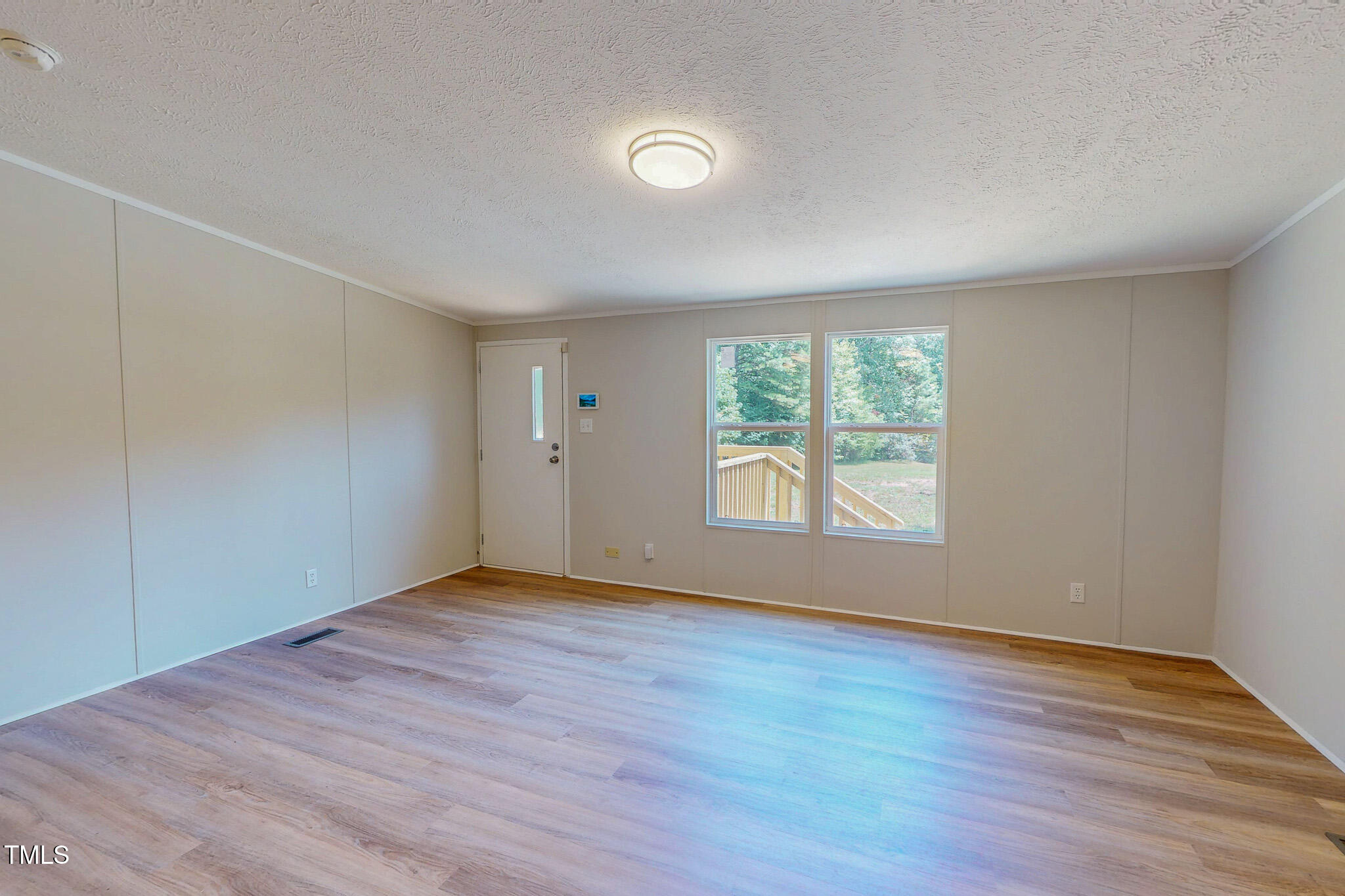 72 Red Field Lane Timberlake, NC 27583 - Photo 23 of 36 an empty room with wooden floor and windows