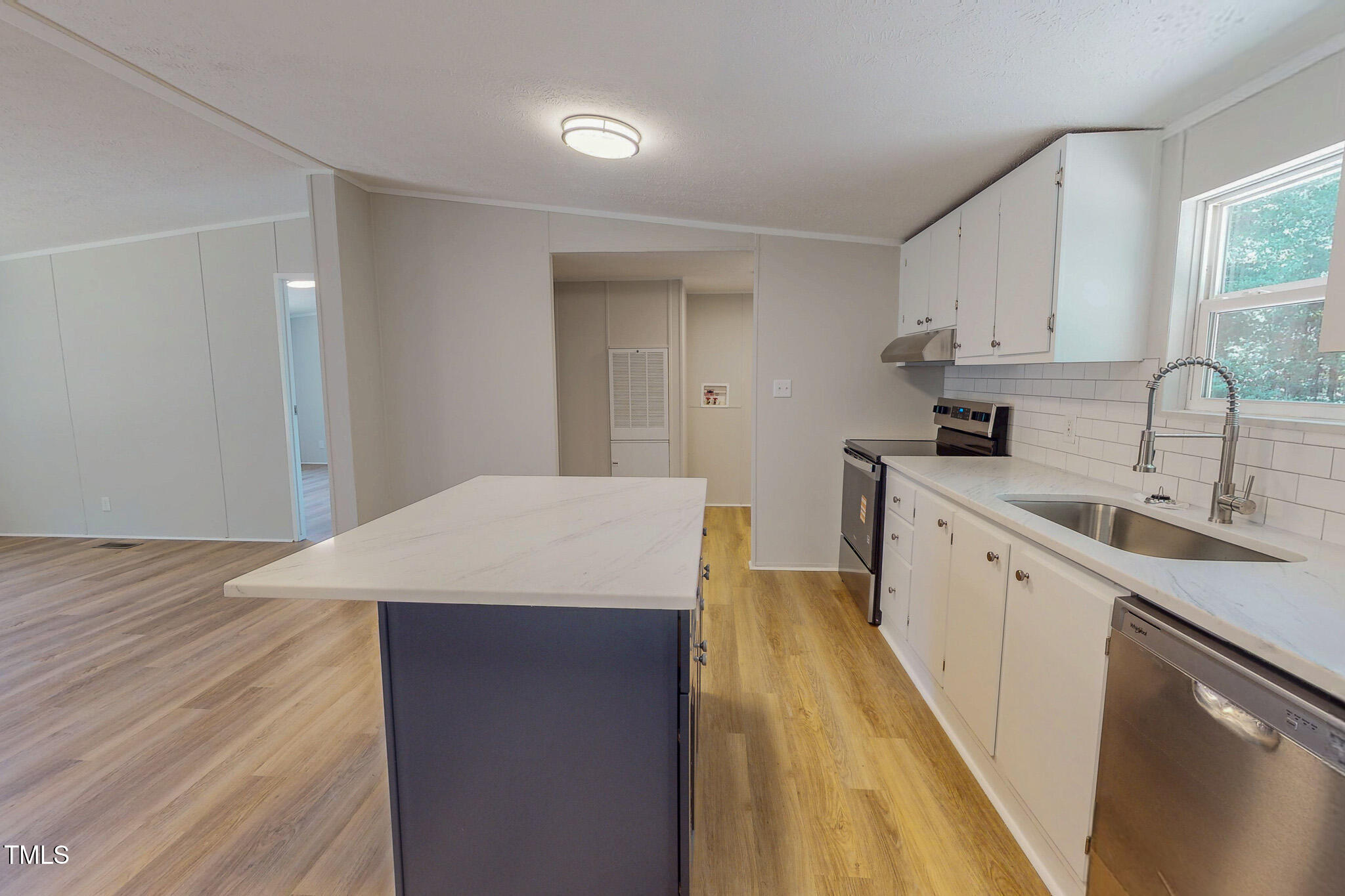 72 Red Field Lane Timberlake, NC 27583 - Photo 27 of 36 a kitchen with a sink a stove cabinets and wooden floor
