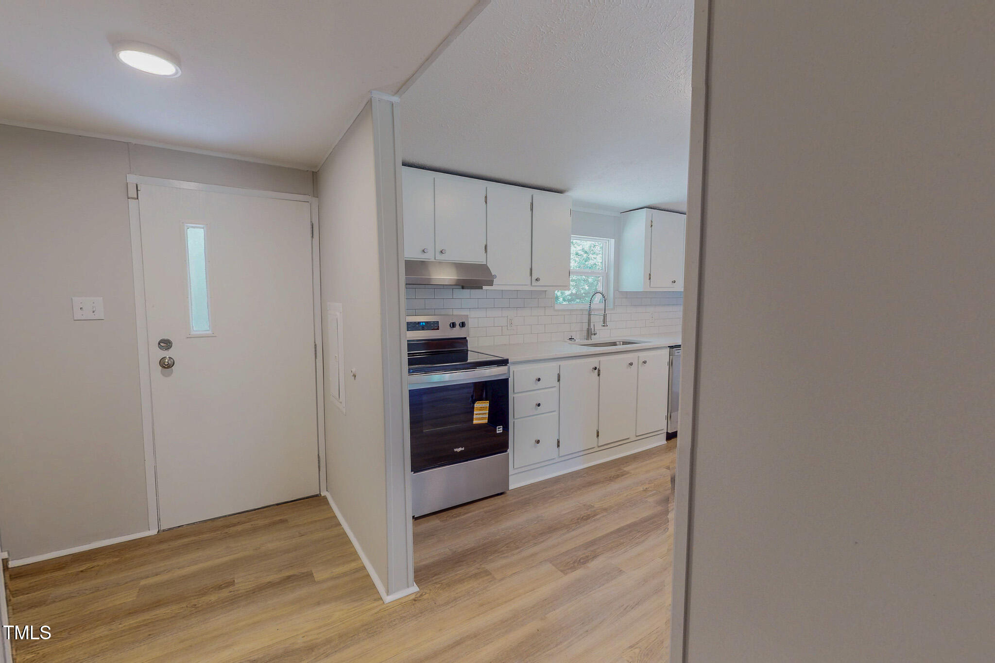 72 Red Field Lane Timberlake, NC 27583 - Photo 28 of 36 a kitchen with stainless steel appliances granite countertop a refrigerator sink and white cabinets