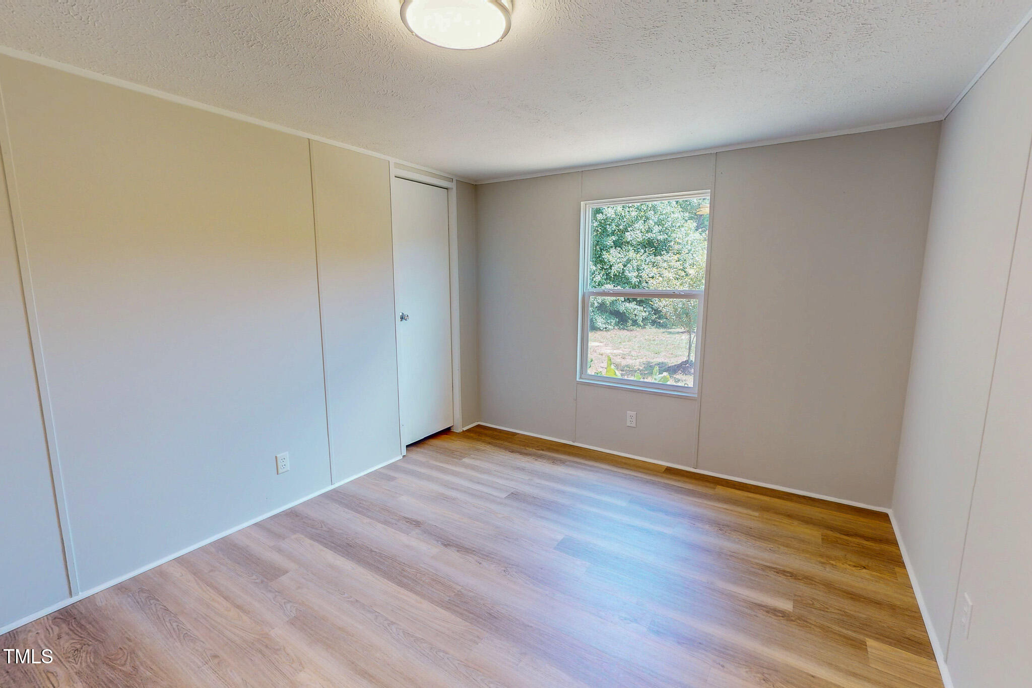 72 Red Field Lane Timberlake, NC 27583 - Photo 32 of 36 a view of an empty room with wooden floor and a window