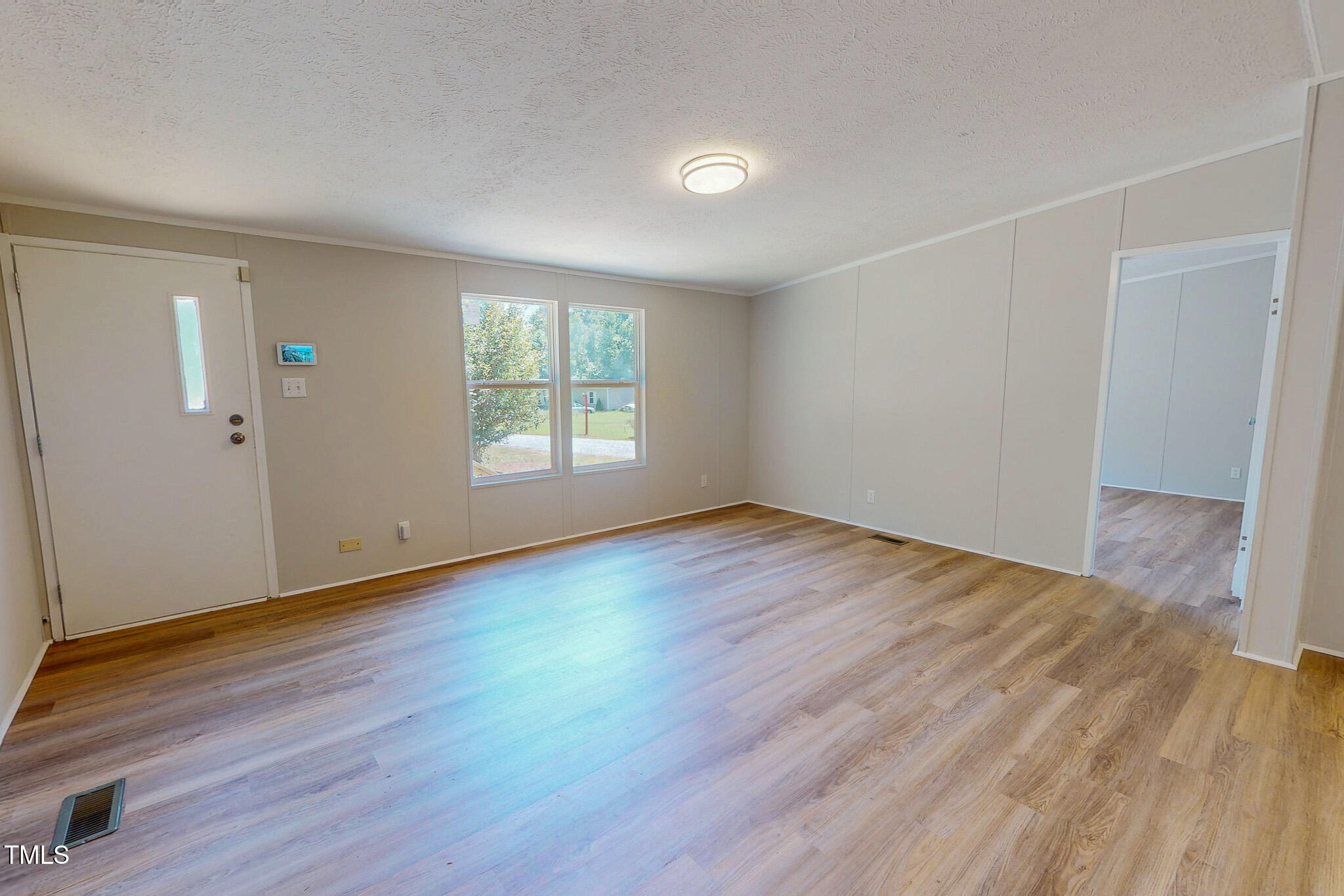 72 Red Field Lane Timberlake, NC 27583 - Photo 9 of 36 an empty room with wooden floor and windows