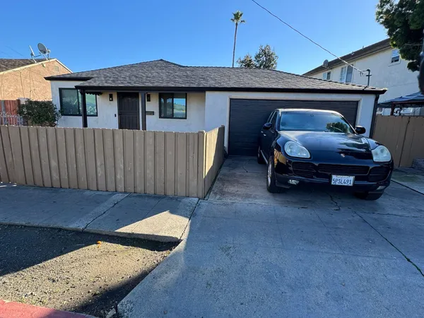 a front view of a house with car parked