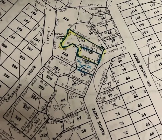 a white house with trees in front of it