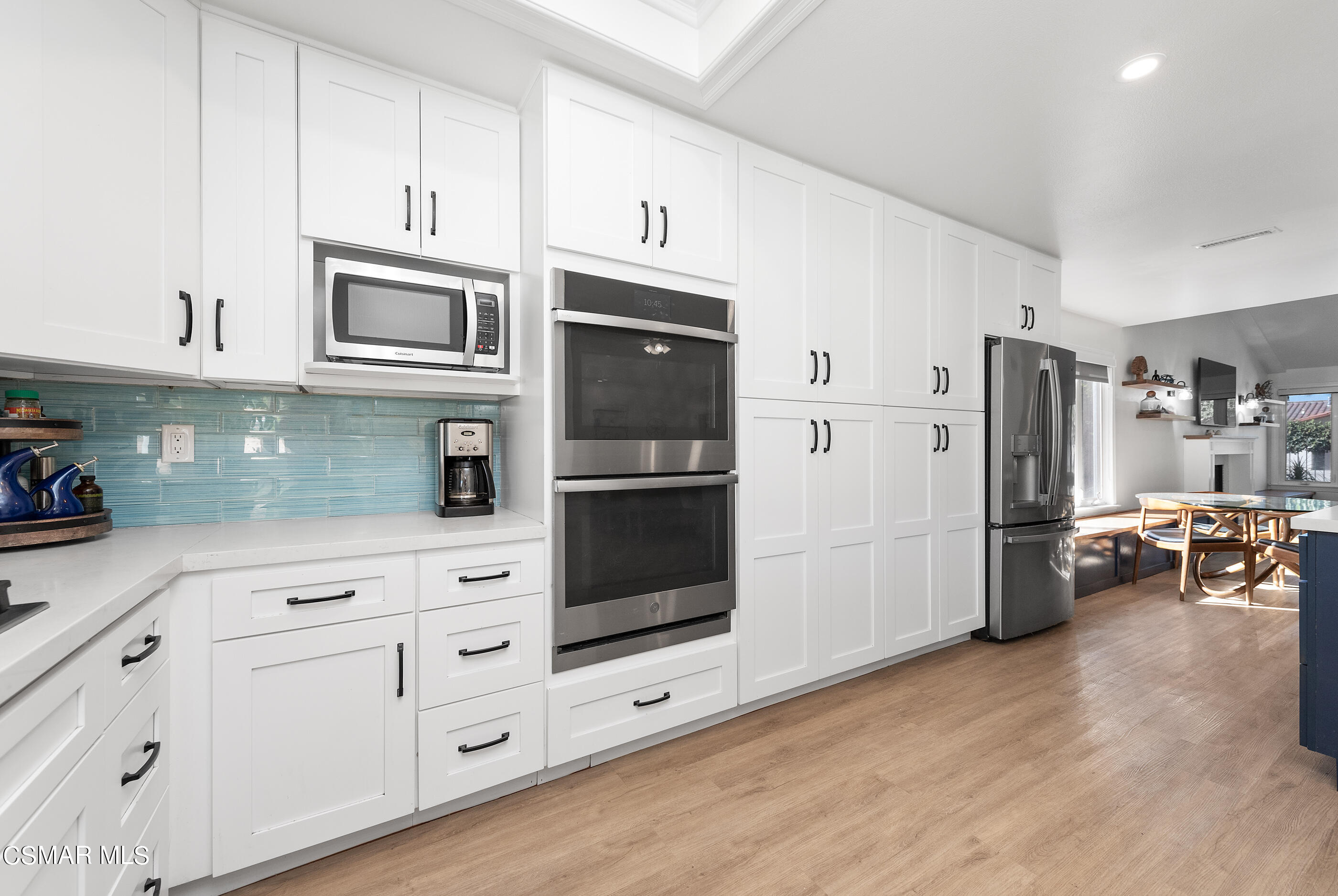3386 Texas Avenue Simi Valley, CA 93063 - Photo 21 of 71 a kitchen with stainless steel appliances white cabinets and wooden floor