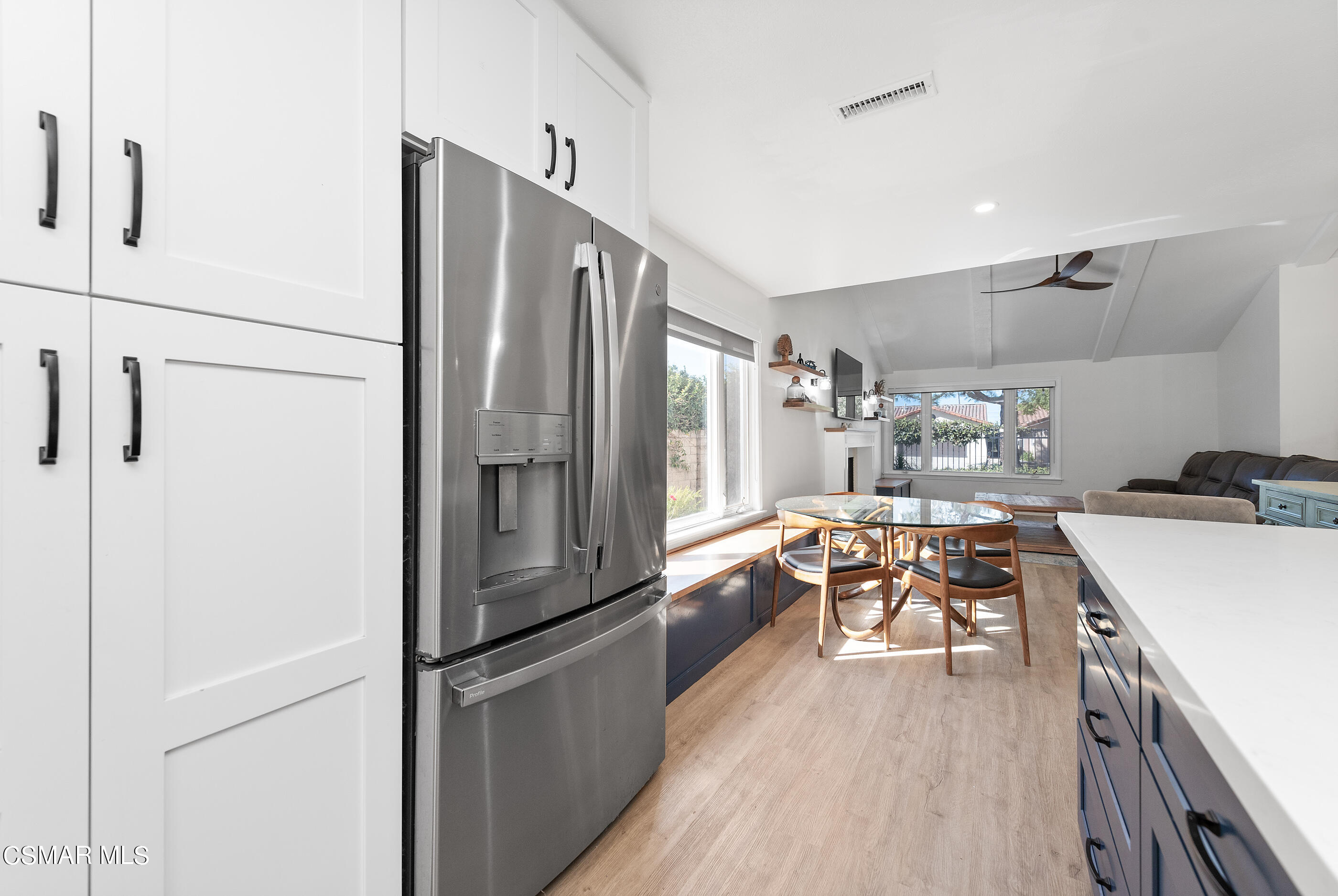 3386 Texas Avenue Simi Valley, CA 93063 - Photo 23 of 71 a kitchen with stainless steel appliances a refrigerator a sink dishwasher a stove and white countertops with wooden floor