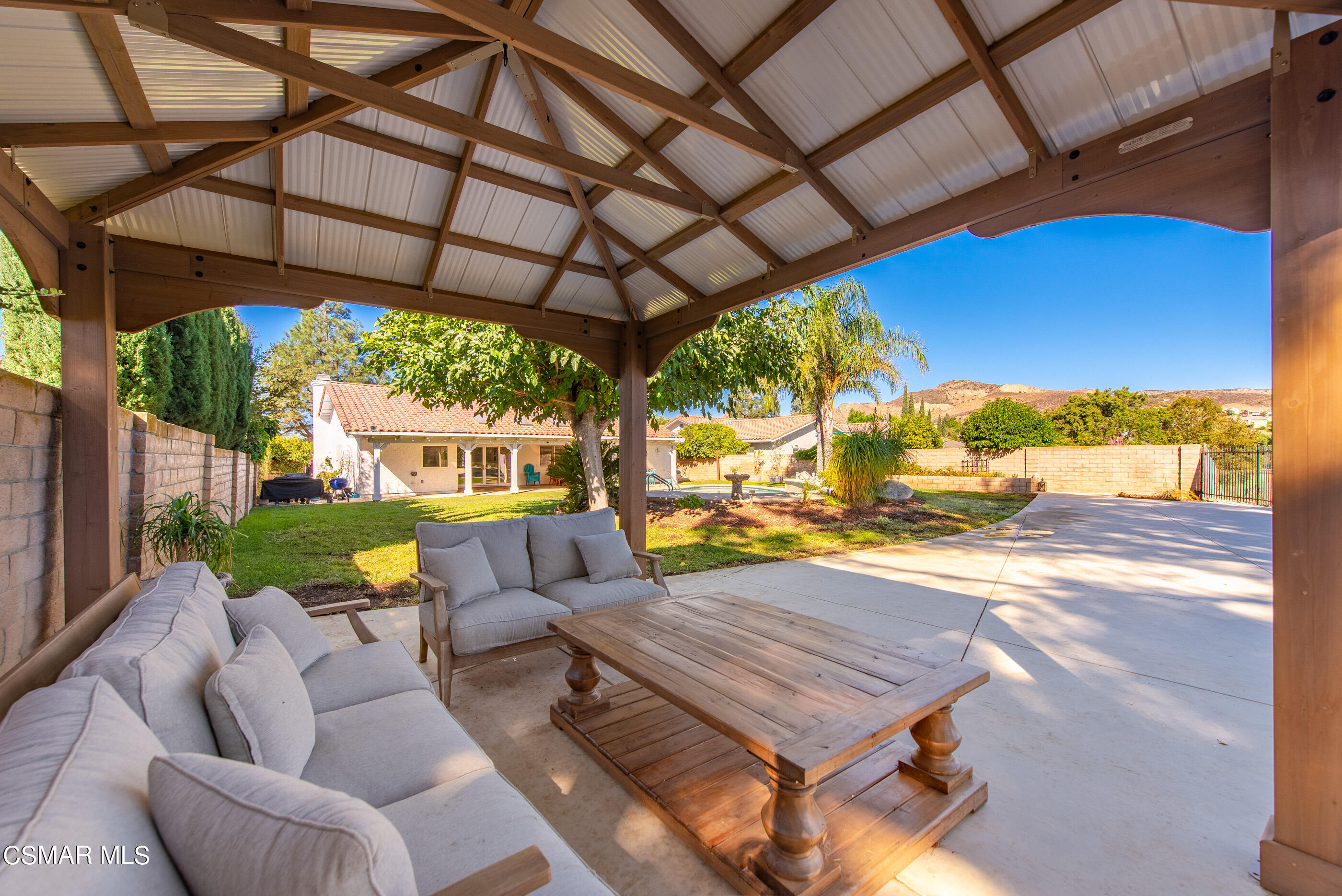 3386 Texas Avenue Simi Valley, CA 93063 - Photo 51 of 71 a view of a patio with a table chairs and a backyard