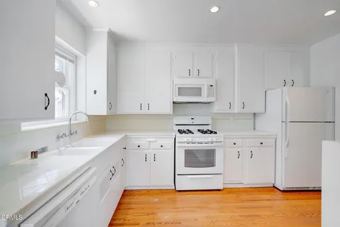 a kitchen with stainless steel appliances a stove a sink and a refrigerator