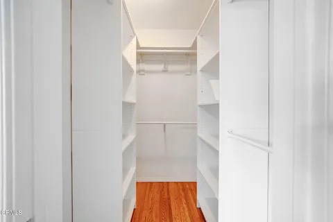 a view of walk in closet with cabinet