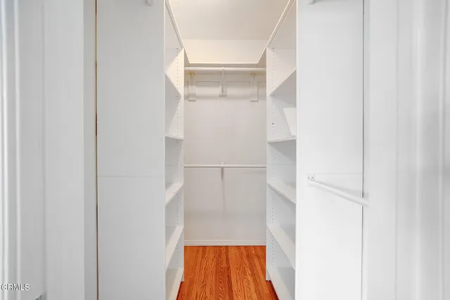 a view of walk in closet with cabinet
