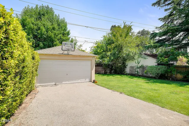 a view of a house with a yard and tree s