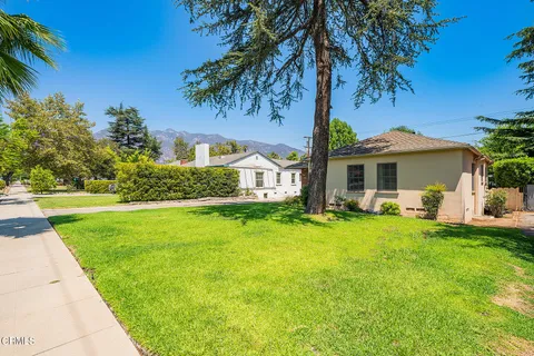 a front view of a house with swimming pool having outdoor seating