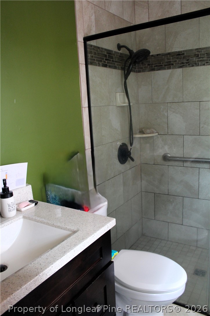 2038 Dunn Road Eastover, NC 28312 - Photo 16 of 29 a bathroom with a sink a toilet and shower