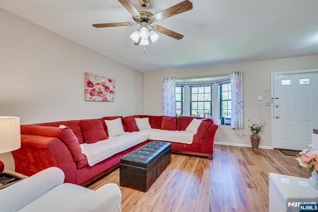 1402 Maplecrest Road, Unit 1402 Edison, NJ 08820 - Photo 15 of 37 a living room with furniture and a chandelier