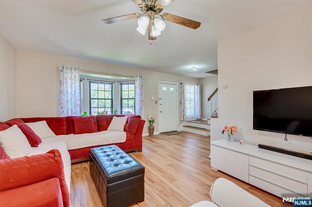 1402 Maplecrest Road, Unit 1402 Edison, NJ 08820 - Photo 16 of 37 a living room with furniture and a flat screen tv