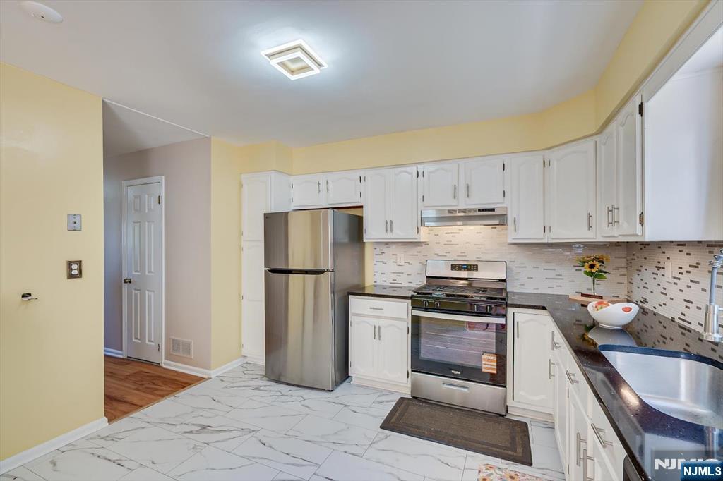 1402 Maplecrest Road, Unit 1402 Edison, NJ 08820 - Photo 20 of 37 a kitchen with a sink a stove and refrigerator