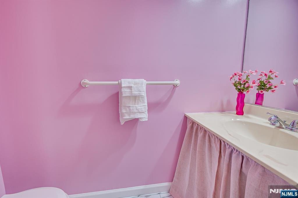 1402 Maplecrest Road, Unit 1402 Edison, NJ 08820 - Photo 23 of 37 a bathroom with a sink a mirror and a toilet