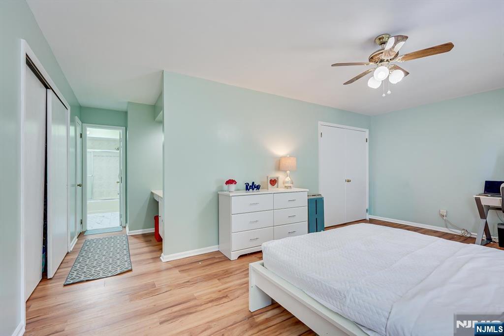 1402 Maplecrest Road, Unit 1402 Edison, NJ 08820 - Photo 27 of 37 a bedroom with a bed and a chandelier