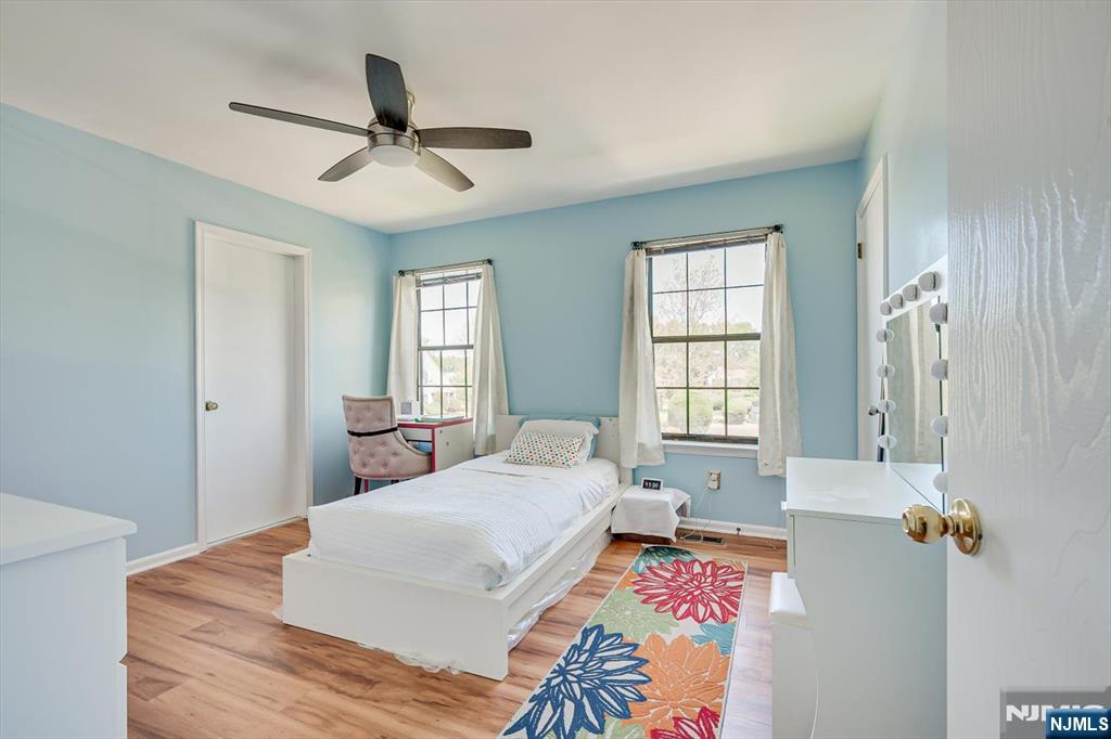 1402 Maplecrest Road, Unit 1402 Edison, NJ 08820 - Photo 30 of 37 a bedroom with a bed and wooden floor