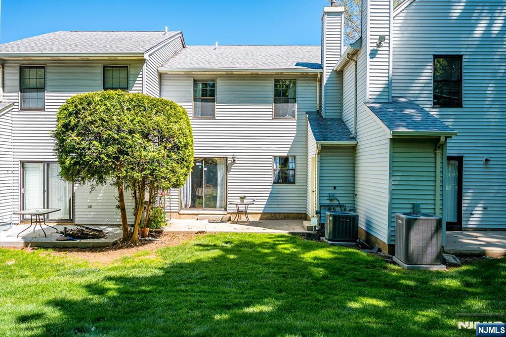 1402 Maplecrest Road, Unit 1402 Edison, NJ 08820 - Photo 33 of 37 a front view of a house with a yard and garage