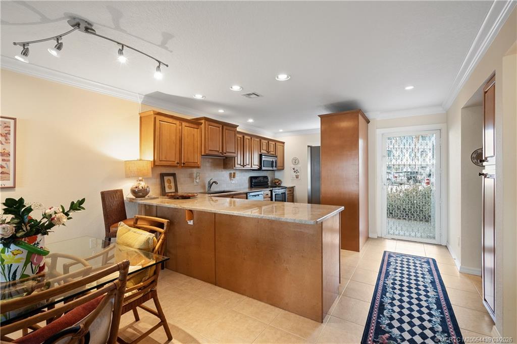 Undisclosed Address Stuart, FL 34994 - Photo 14 of 43 a kitchen with stainless steel appliances a refrigerator and a stove top oven