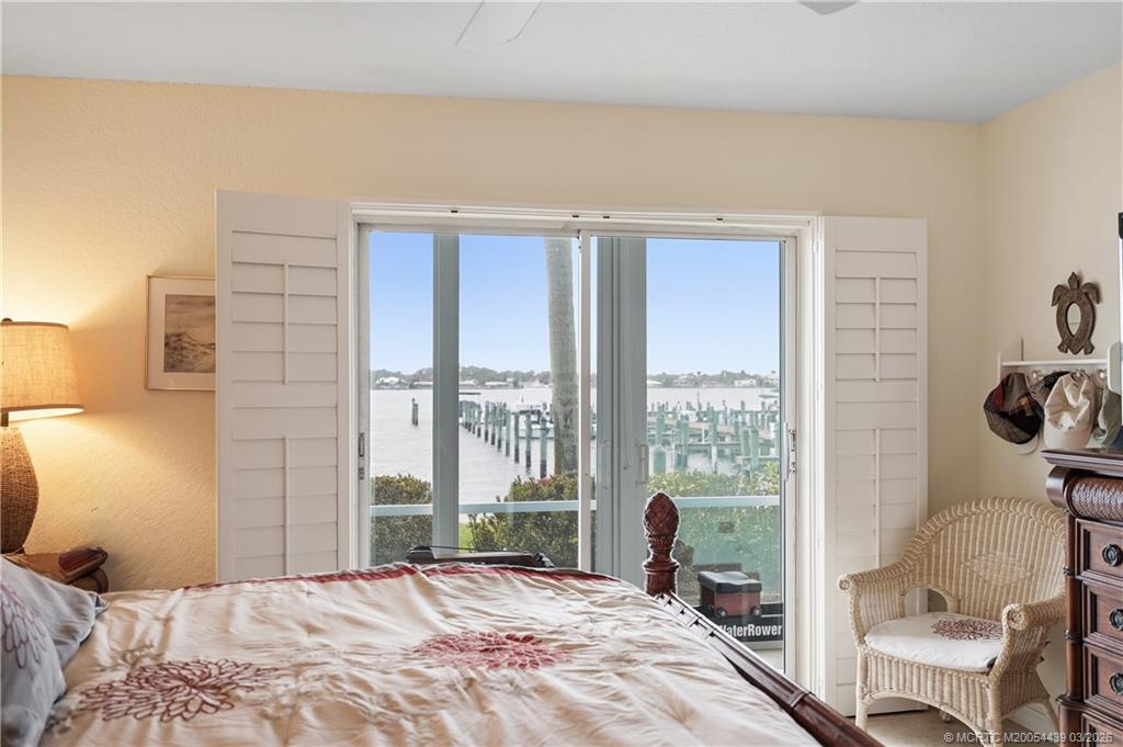 Undisclosed Address Stuart, FL 34994 - Photo 20 of 43 a bedroom with a bed and a large window