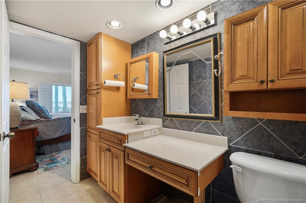 Undisclosed Address Stuart, FL 34994 - Photo 22 of 43 a bathroom with a sink and a mirror