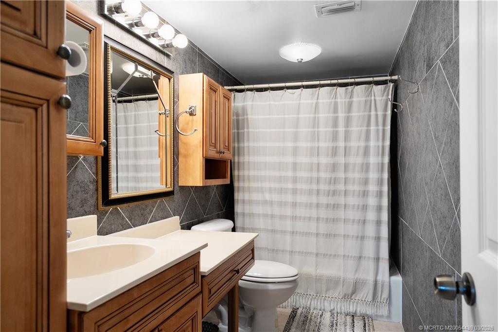 Undisclosed Address Stuart, FL 34994 - Photo 23 of 43 a bathroom with a sink a toilet and shower