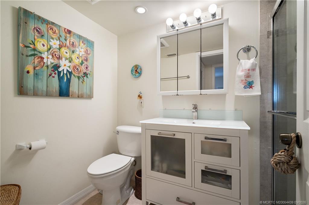 Undisclosed Address Stuart, FL 34994 - Photo 27 of 43 a bathroom with a sink a toilet and mirror