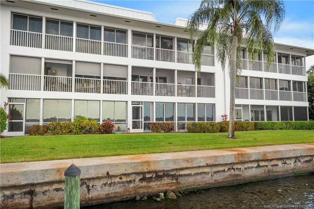 Undisclosed Address Stuart, FL 34994 - Photo 34 of 43 a view of a brick building next to a yard