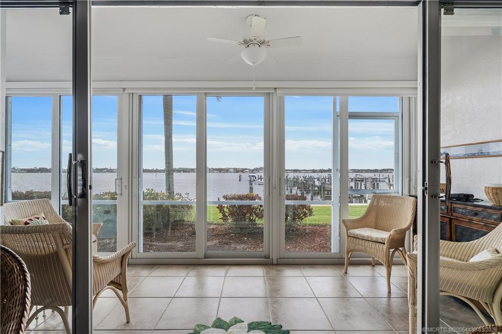 Undisclosed Address Stuart, FL 34994 - Photo 9 of 43 a living room with furniture and a floor to ceiling window