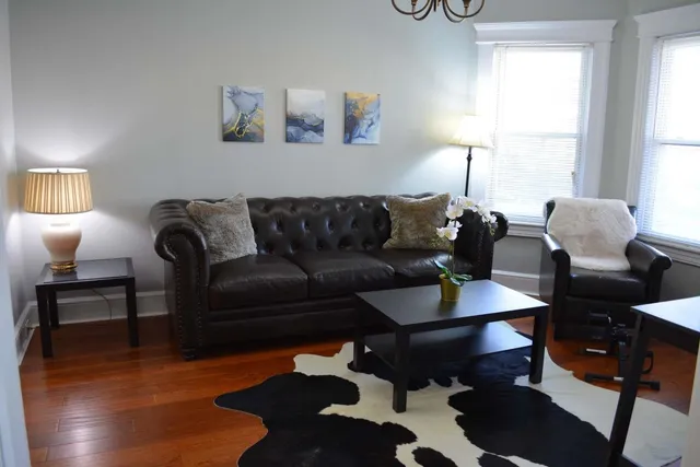 a living room with furniture and a lamp