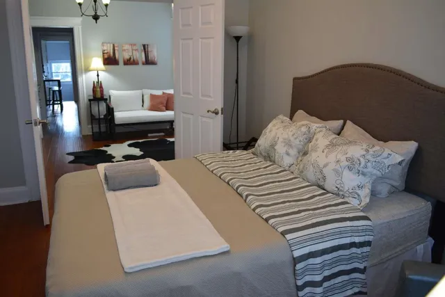 a bedroom with a bed and wooden floor