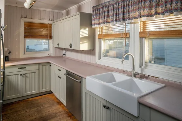 a kitchen with a sink cabinets and window