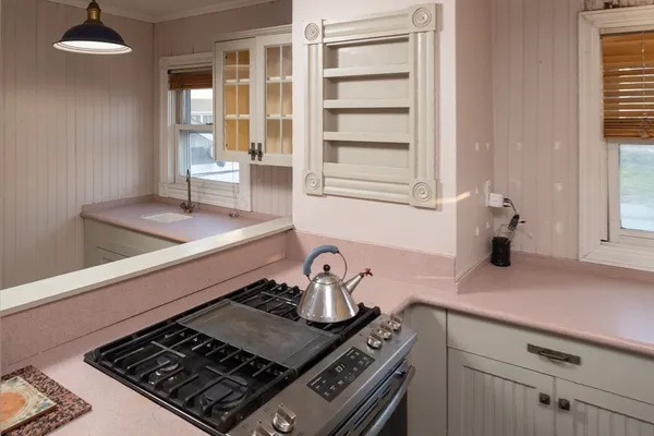 a kitchen with a stove and a cabinet